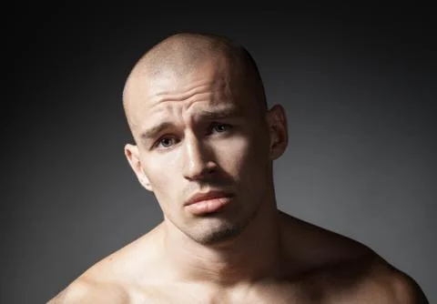 Portrait of pitiful strong man isolated on gray background Stock Photos