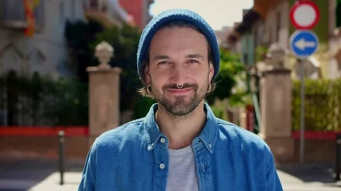 Portrait of pleasant handsome Hispanic guy with piercing smiling standing at Stock Footage 111071053