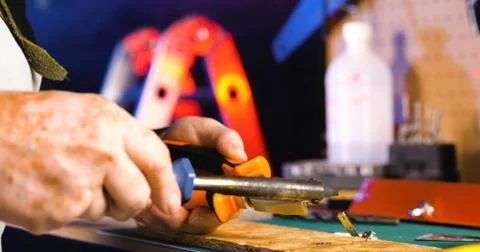 Portrait of pleasing old man working in modern industrial workshop. Stock Photos