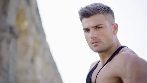 Portrait posing of young strong man with a deep gaze on the background of city Video stock 91508559