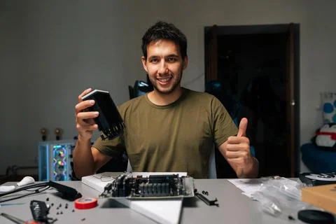 Portrait of positive computer technician installing CPU cooler on motherboard Stock Photos