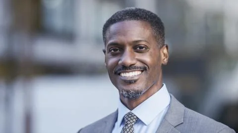 Portrait of positive handsome black professional smiling to camera Stock Photos