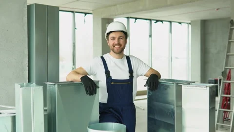 Portrait of positive hvac worker with ventilation pipes on construction site Stock-Footage 239092404