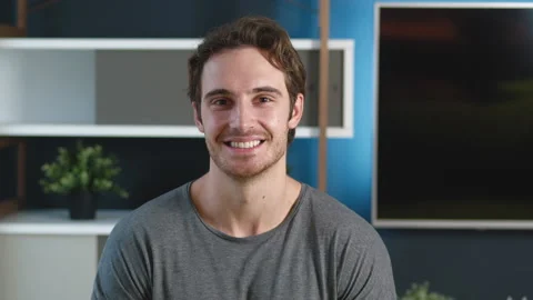 Portrait of positive man face looking camera indoors. Smiling handsome young Vídeos de archivo 142846926