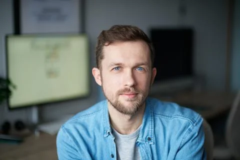 Portrait of positive programmer or software engineer looking at camera in office Stock-Fotos