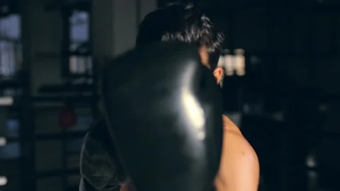 Portrait of powerfull, agressive boxer. Training in box and fast hitting. Stock Footage 98679802