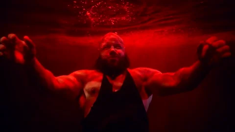 Portrait of powerlifter inside water of pool or aquarium, man with large arms is Stock Footage 171065843