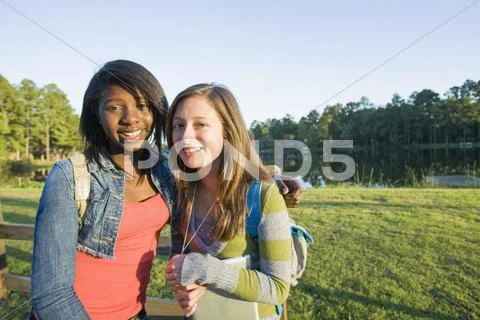 Portrait of pre-teen girls smiling and looking at camera, outdoors Stock-Fotos