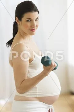 Portrait of pregnant woman exercising Stock Photos