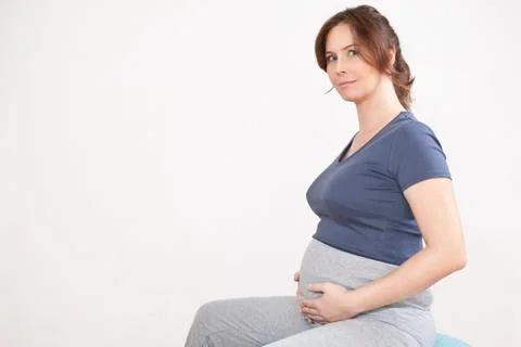Portrait of a pregnant woman sitting on exercise ball, portrait Stock Photos