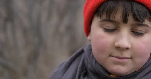 Portrait of a pretty boy in a red cap Stock Footage 88399526
