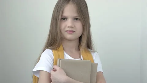 Portrait of pretty cute smiling school girl in white t-short with yellow Video stock 168435023