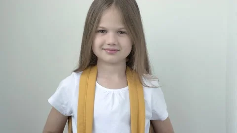 Portrait of pretty cute smiling school girl in white t-short with yellow Stock Footage 169467585