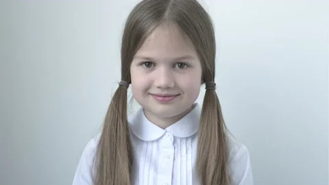 Portrait of pretty cute smiling school girl in uniform on gray background Video stock 208892420
