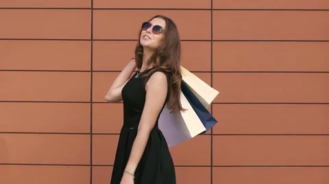 Portrait of pretty fair-skinned young woman playing with shopping bags Stockbeeldmateriaal 67875678