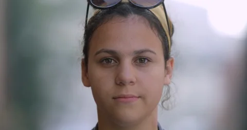 Portrait of Pretty Smiling Mixed Race Teen Girl with Hair Bun, Headscarf. Stock Footage 91237246