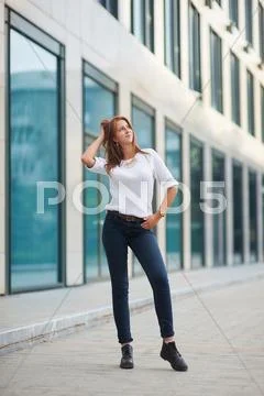 Portrait of pretty young business woman near building Stock Photos
