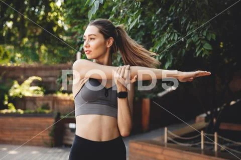 Portrait of a pretty young fitness girl doing stretching Stock Photos