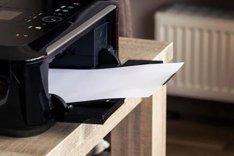 A portrait of a printer with an empty white piece of paper in its printed out Stock Photos