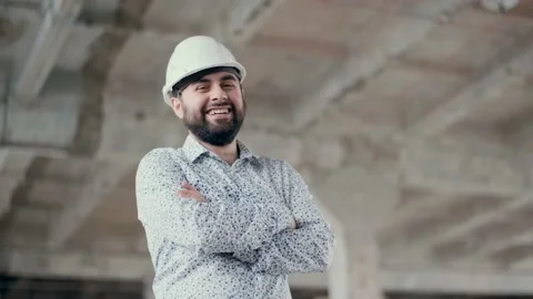 Portrait of a professional builder engineer. Worker wearing white safety helmet Stock Footage 130775353