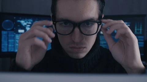 Portrait of professional hacker programmer in glasses working on computer in Stock Footage 101405869