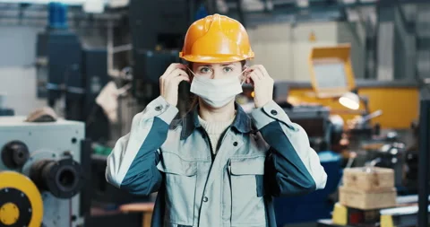 Portrait of a professional heavy industry engineer worker putting on a face Stock Footage 167787041