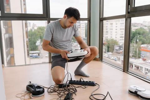 Portrait of professional window technician testing advanced robotic system for Stock Photos