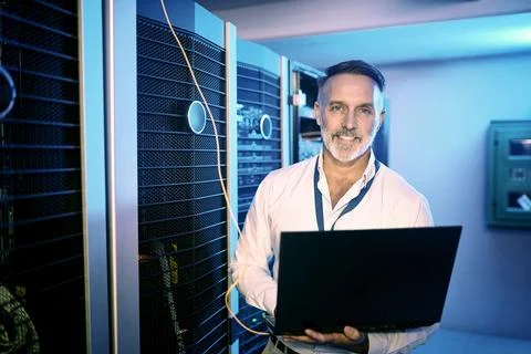 Portrait, programmer and man in server room, laptop and cyber security with Stock-Fotos