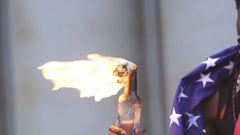Portrait of protesting activist in mask and Molotov cocktail in hands. Slow Stock Footage 131930436