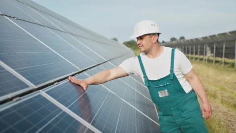 Portrait of proud worker industrial engineer in uniform standing on field with Stock Footage 158820874