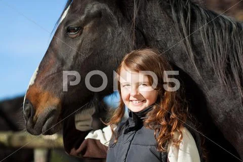 Portrait of a proud young girl with her horse Stock Photos
