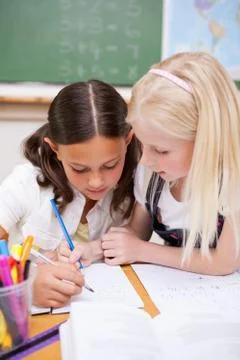 Portrait of pupils working together on an assignment Stock Photos