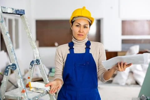 Portrait of questionable woman builder with documentation Stock Photos