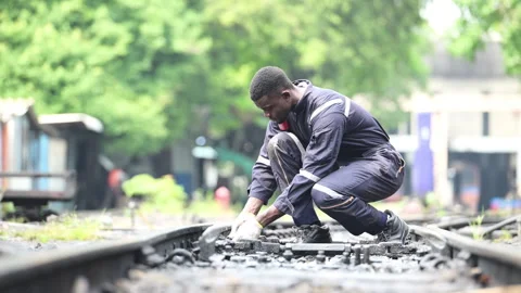 Portrait of a railway engineer on the tracks of a train in station platform Video stock 274875065