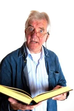 Portrait of a reading elderly man Stock Photos