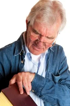 Portrait of a reading elderly man Stock Photos