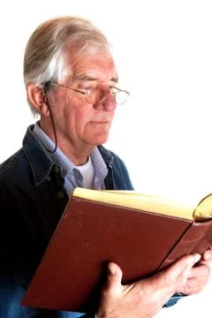 Portrait of a reading elderly man Stock Photos