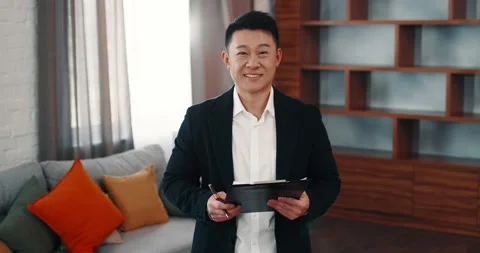 Portrait of Real Estate Agent posing in Apartment with Documents Video stock 220624069