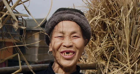 Portrait of real unique authentic Asian Chinese village woman farmer with grass Stock Footage 201096000