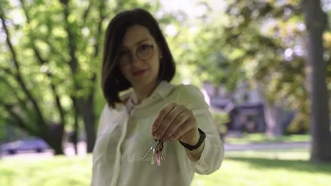 Portrait of Realtor throwing keys. Real estate agent posing with keys from house Stock Footage 244246807
