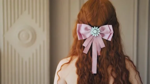 Portrait rear view red-haired girl princess curly long hair hairstyle with bow Stock Footage 201093332