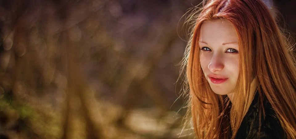 Portrait of a red-haired beautiful girl in forest Stock Photos