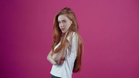 The portrait of a red-haired, charismatic young woman, looks forward confidently Stock-Footage 153696790