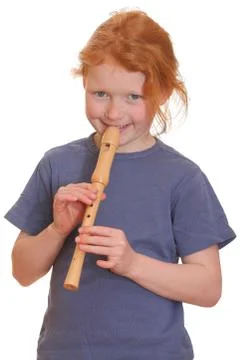 Portrait of a red-haired girl playing flute Stock Photos