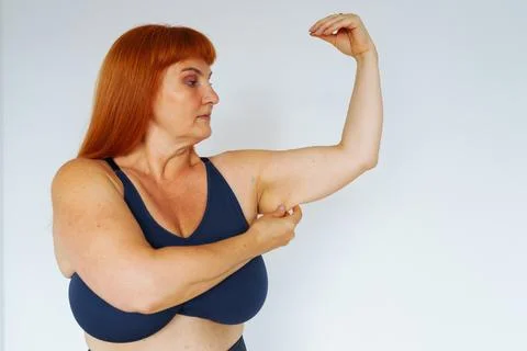 Portrait red-haired middle-aged woman, plump, with large bust size, doing Stock Photos