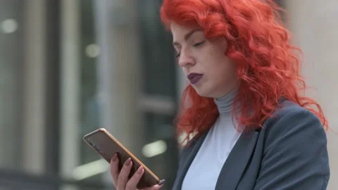 Portrait of a red-haired woman using a smartphone Video stock 163631427
