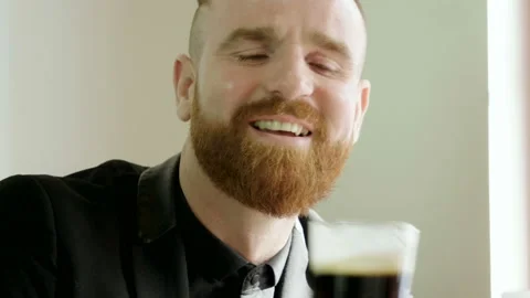 Portrait of redhead man with a beard drinking beer with friends in a pub. 4K 库存影片 91088498