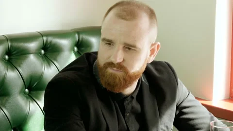 Portrait of redhead man with a beard talking with friends in a pub. 4K Stock-Footage 91132795