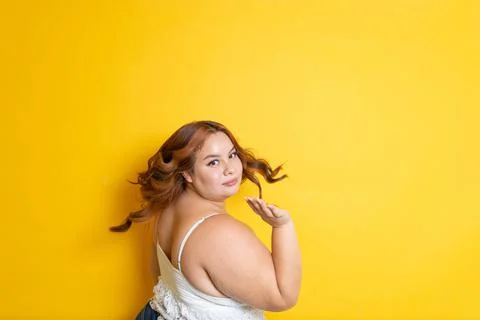 Portrait of redhead plus size model playing with her hair and making it float Photos
