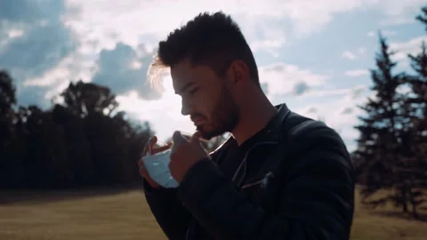 A portrait reflected by the sunlight puts on his face mask. Stock Footage 131664729